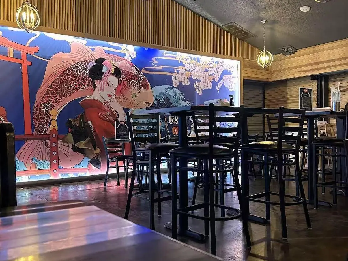 Restaurant Interior - Dining area featuring a vibrant mural of a geisha and koi fish at Koi Ramen&Sushi, a Japanese restaurant in Hutchinson
